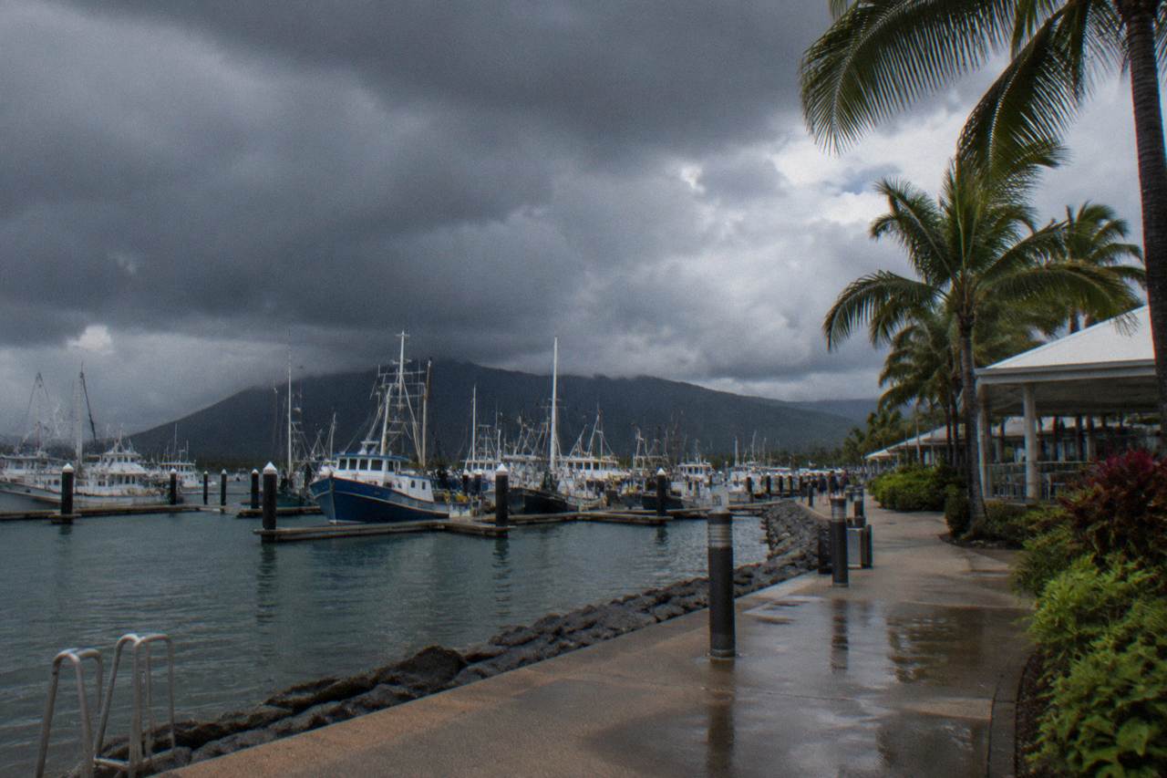 Rain clouds gathering over the Cairns esplanade and harbour before a tropical downpour