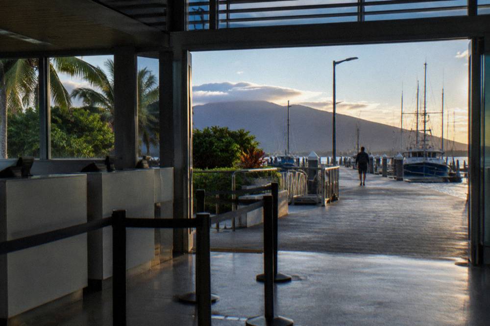 A departure terminal counter and marina boardwalk at the Cairns waterfront
