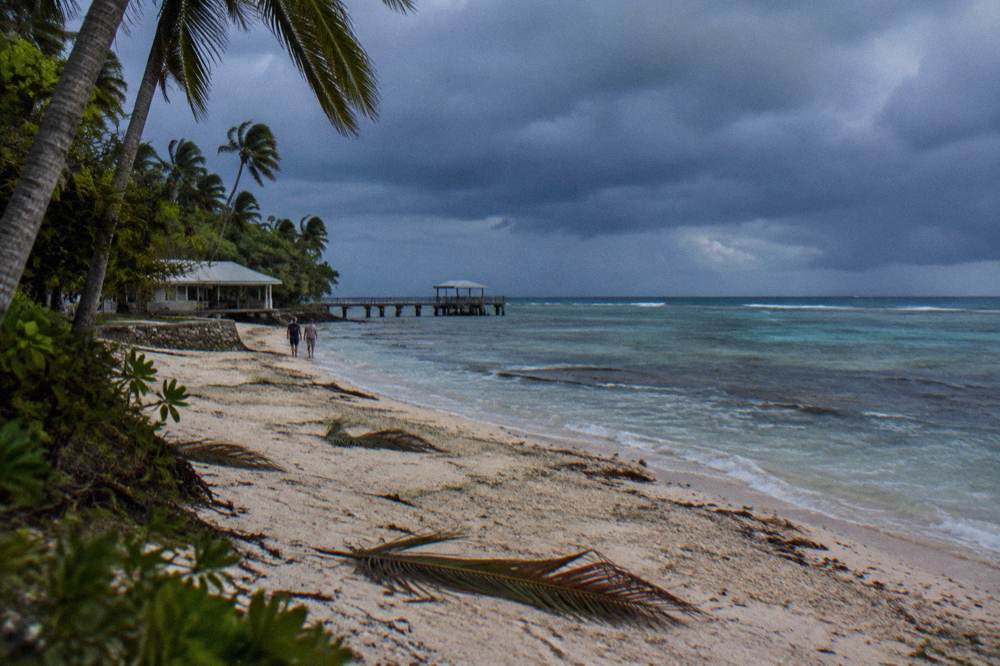 Dark storm clouds building over the Coral Sea horizon from a tropical beach